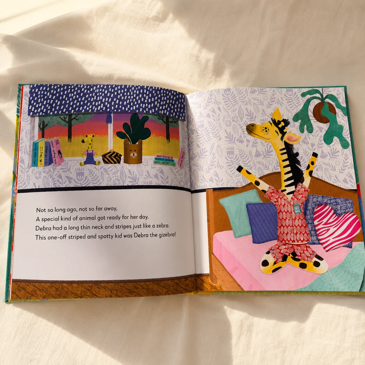 The book open flat, showing a full-colour illustrated spread